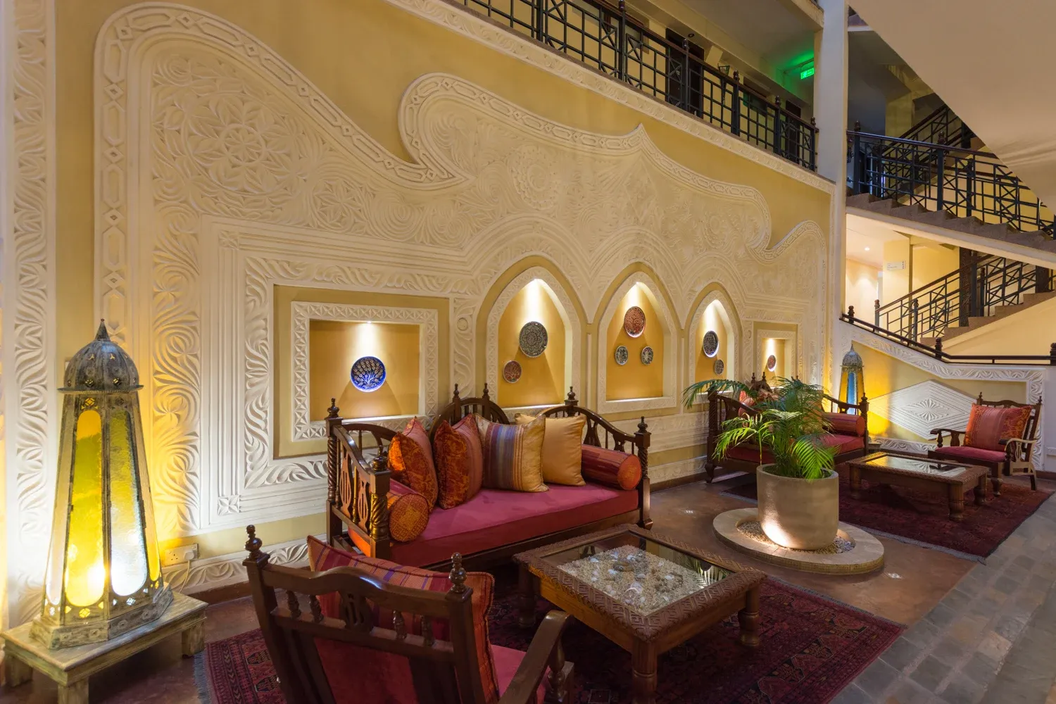 Heron Hotel lounge with carved plaster walls, decorative lanterns and timber seating