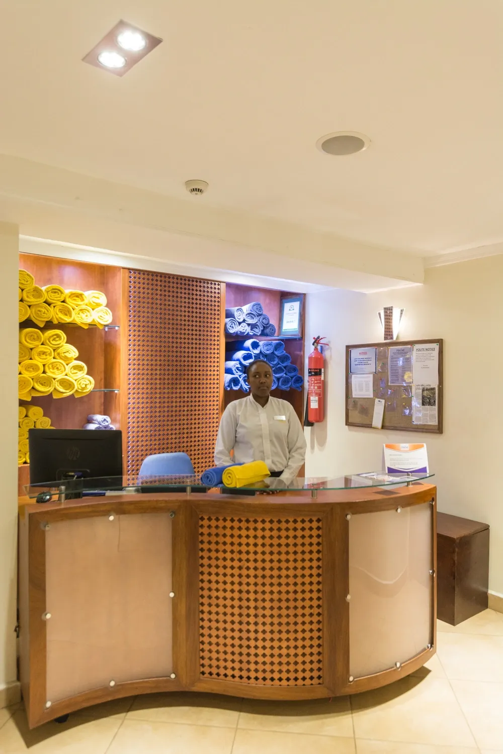 Reception area with a timber counter — Heron Portico Hotel