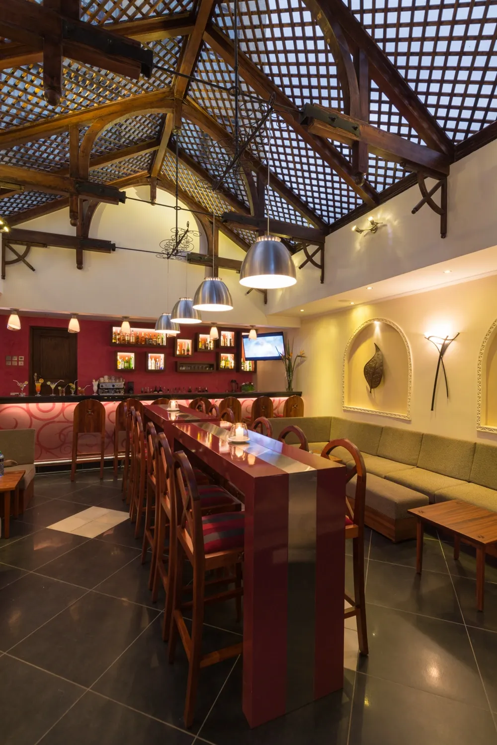 Bar seating beneath a timber roof — Heron Portico Hotel