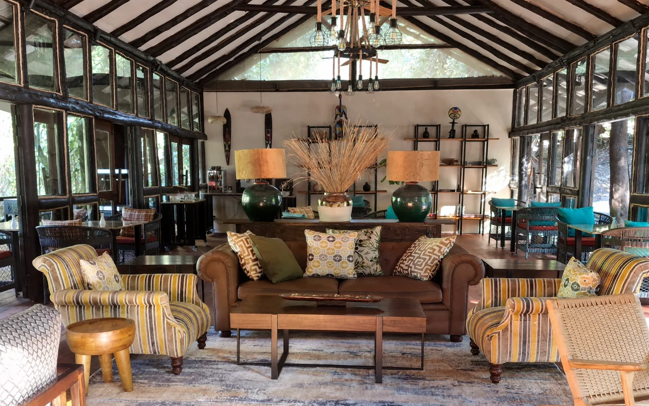 Olchani lounge with timber roof beams, sofas and striped armchairs