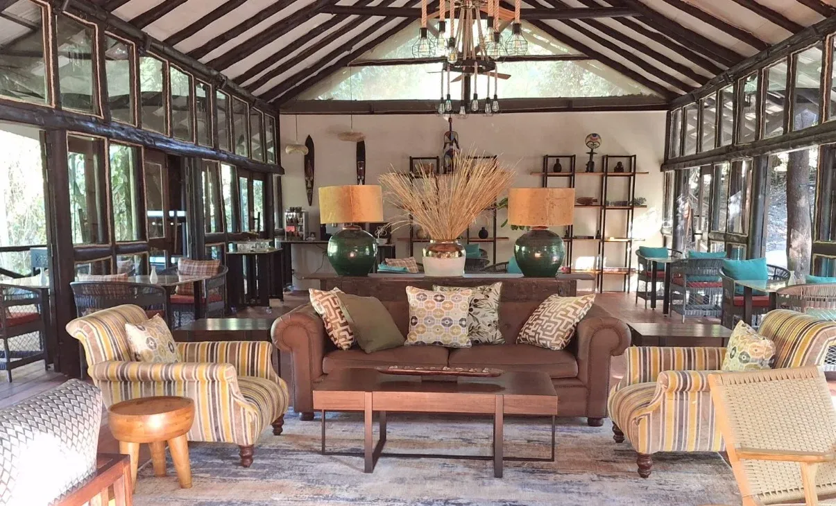 Olchani lounge with timber roof beams, sofas and striped armchairs