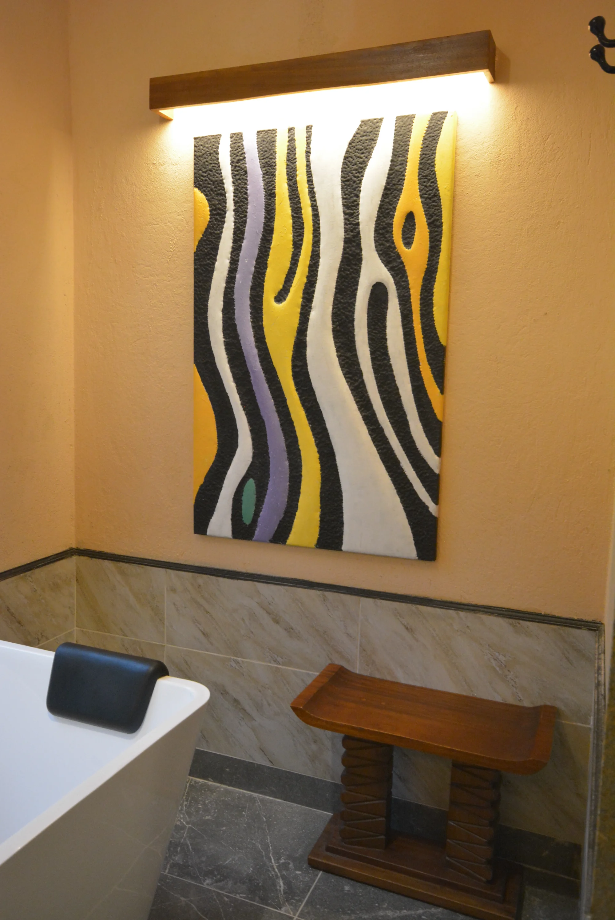 Black, white and yellow textile artwork beside the bath in a Sarova Mara Club Tent