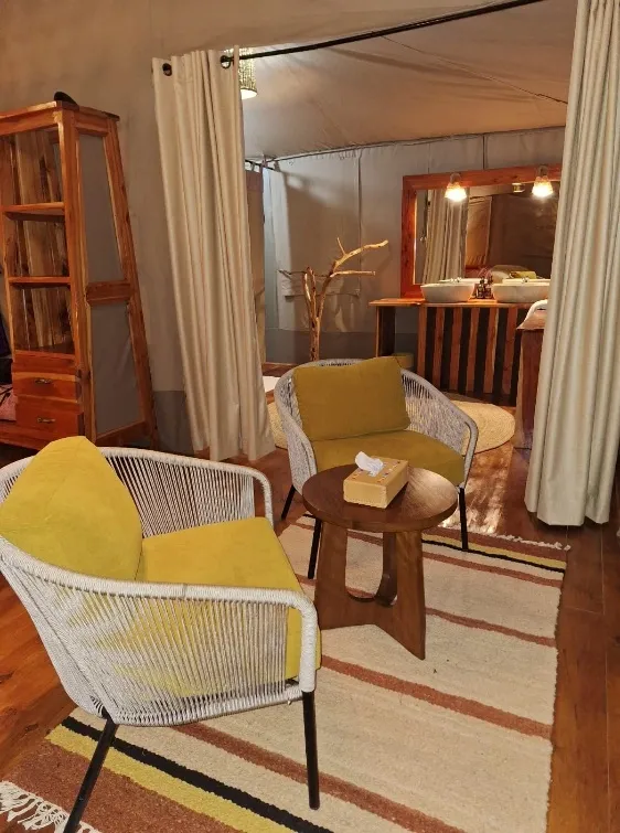 Upholstered chairs inside a guest tent — Mara Siana Tented Camp