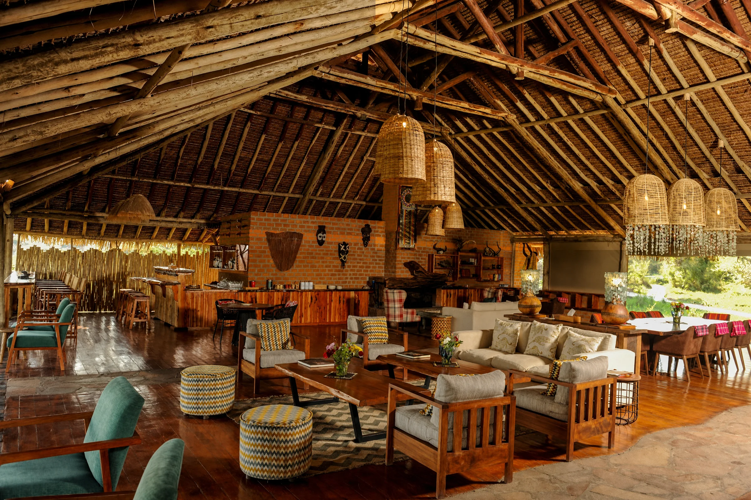 Mara Siana mess area beneath a thatched roof, with timber furniture and woven pendant lights
