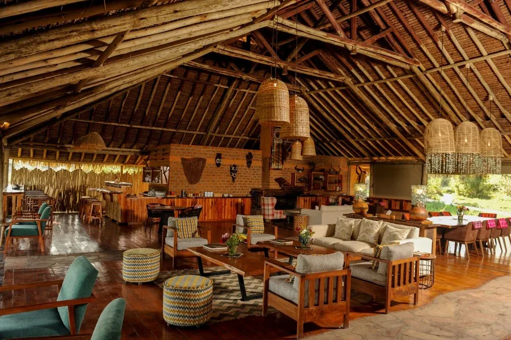 Mara Siana mess area beneath a thatched roof, with timber furniture and woven pendant lights