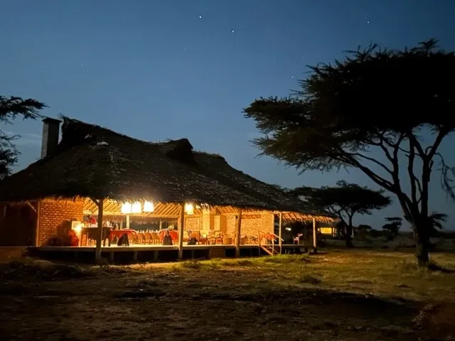 Camp exterior illuminated at night — Mara Siana Tented Camp
