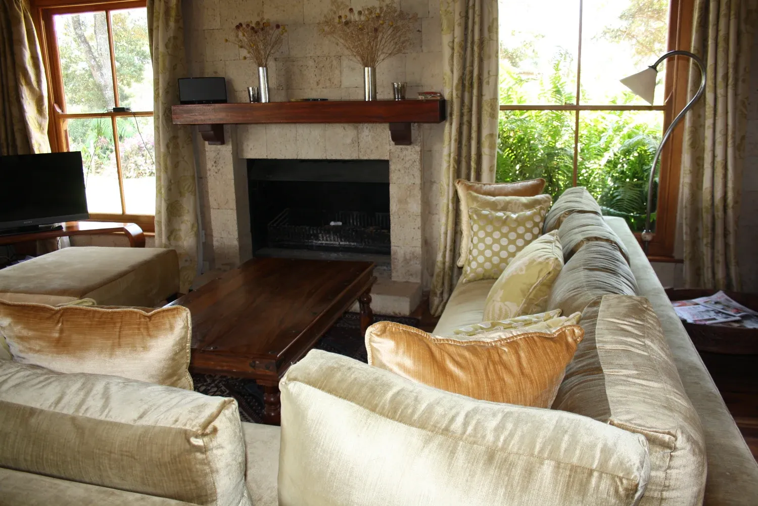 Ngong seating area with pale upholstered sofas beside a fireplace