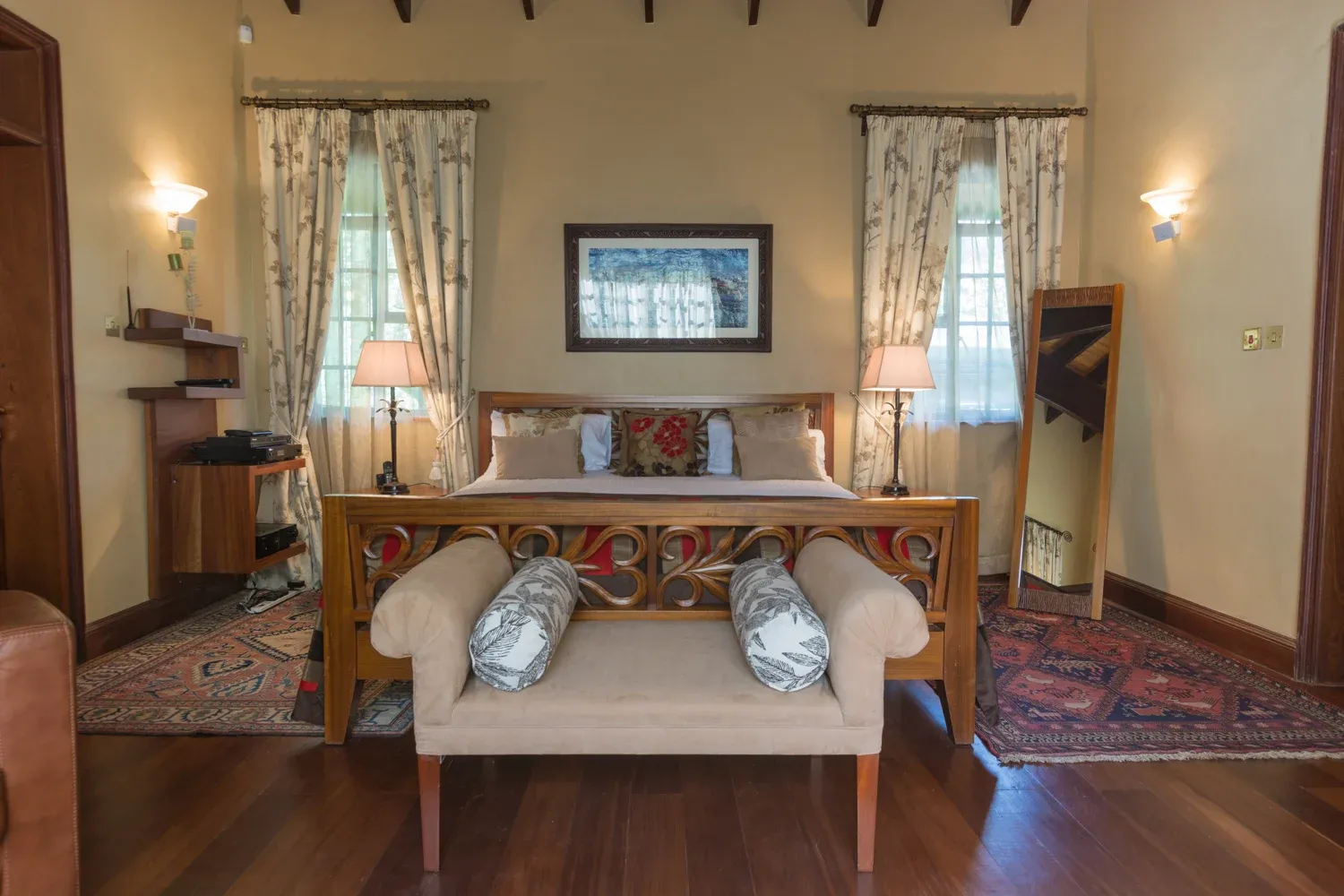 Living room in Mbogani with timber floors, framed art and patterned seating