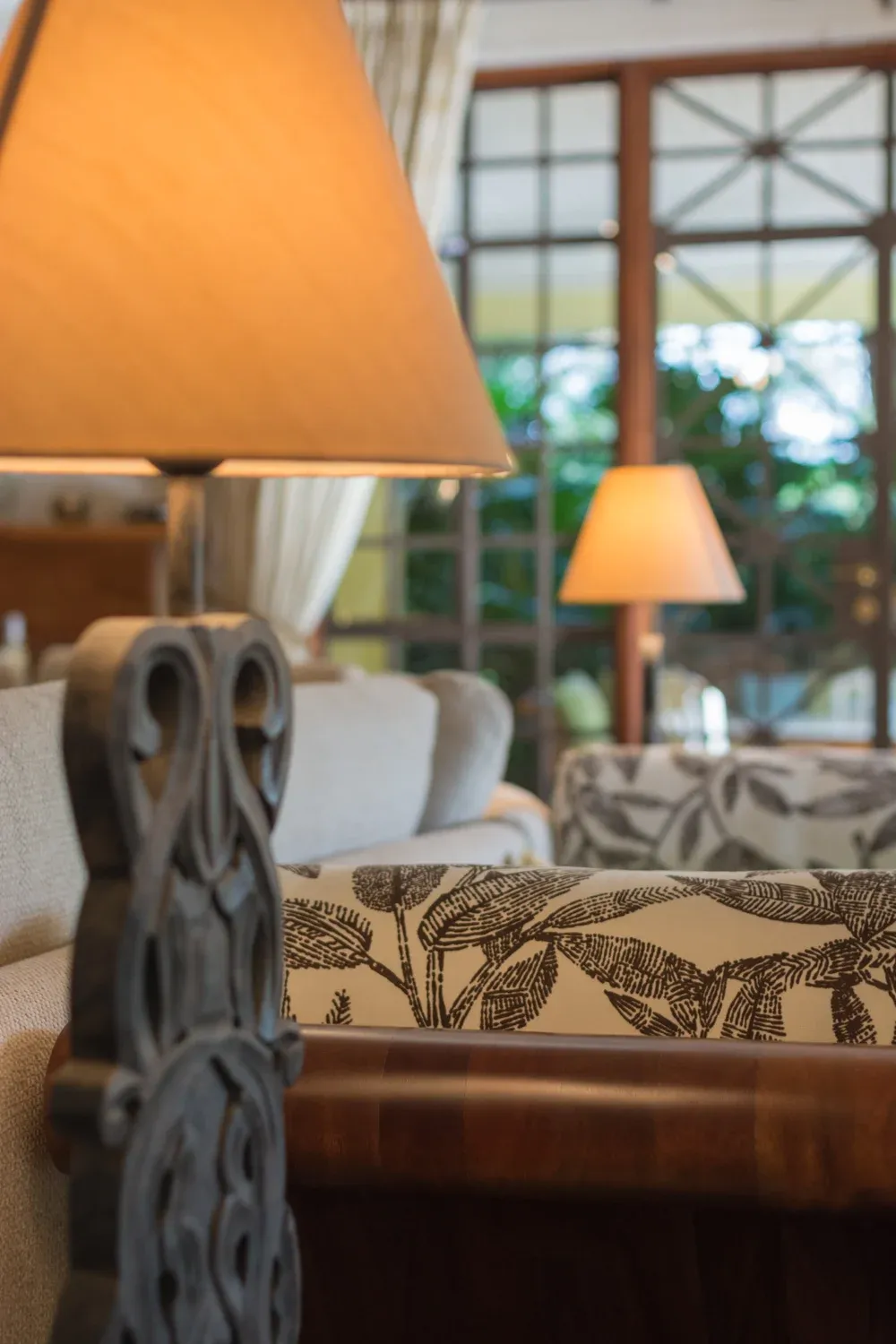 Sculptural table lamp and upholstered chair in Mbogani