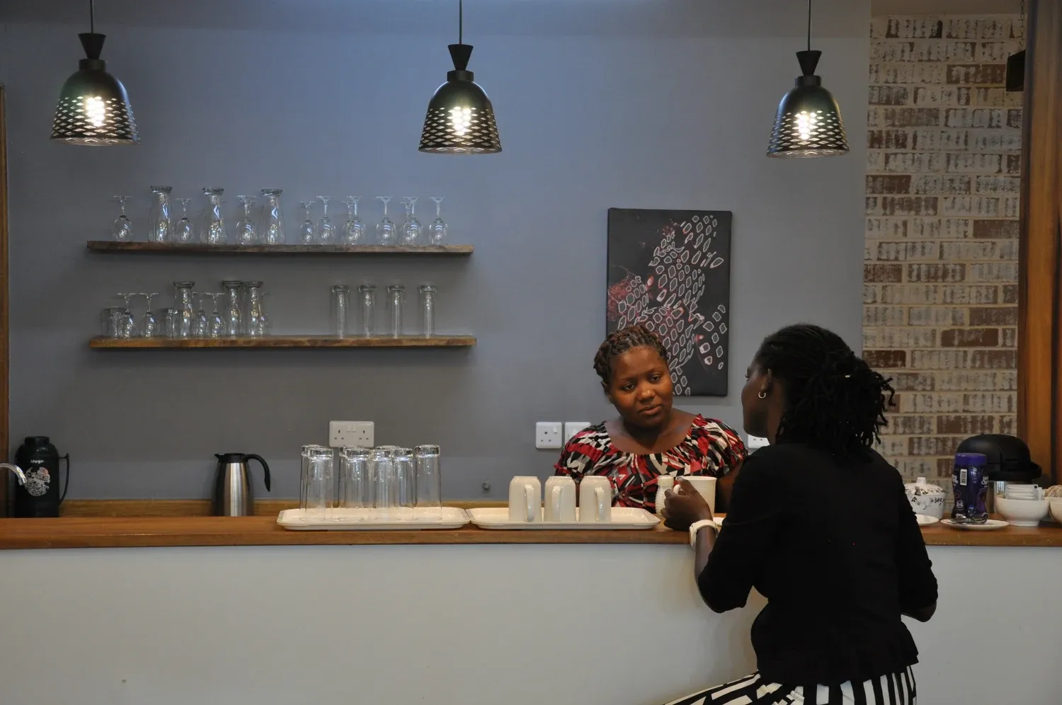 Sustainet coffee bar with pendant lighting and open shelves