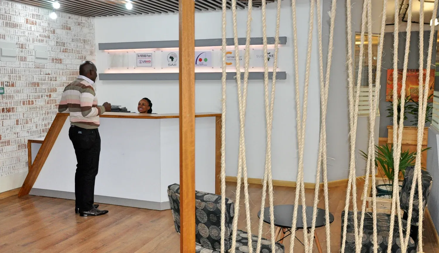 Sustainet reception desk beside a rope divider and timber floor