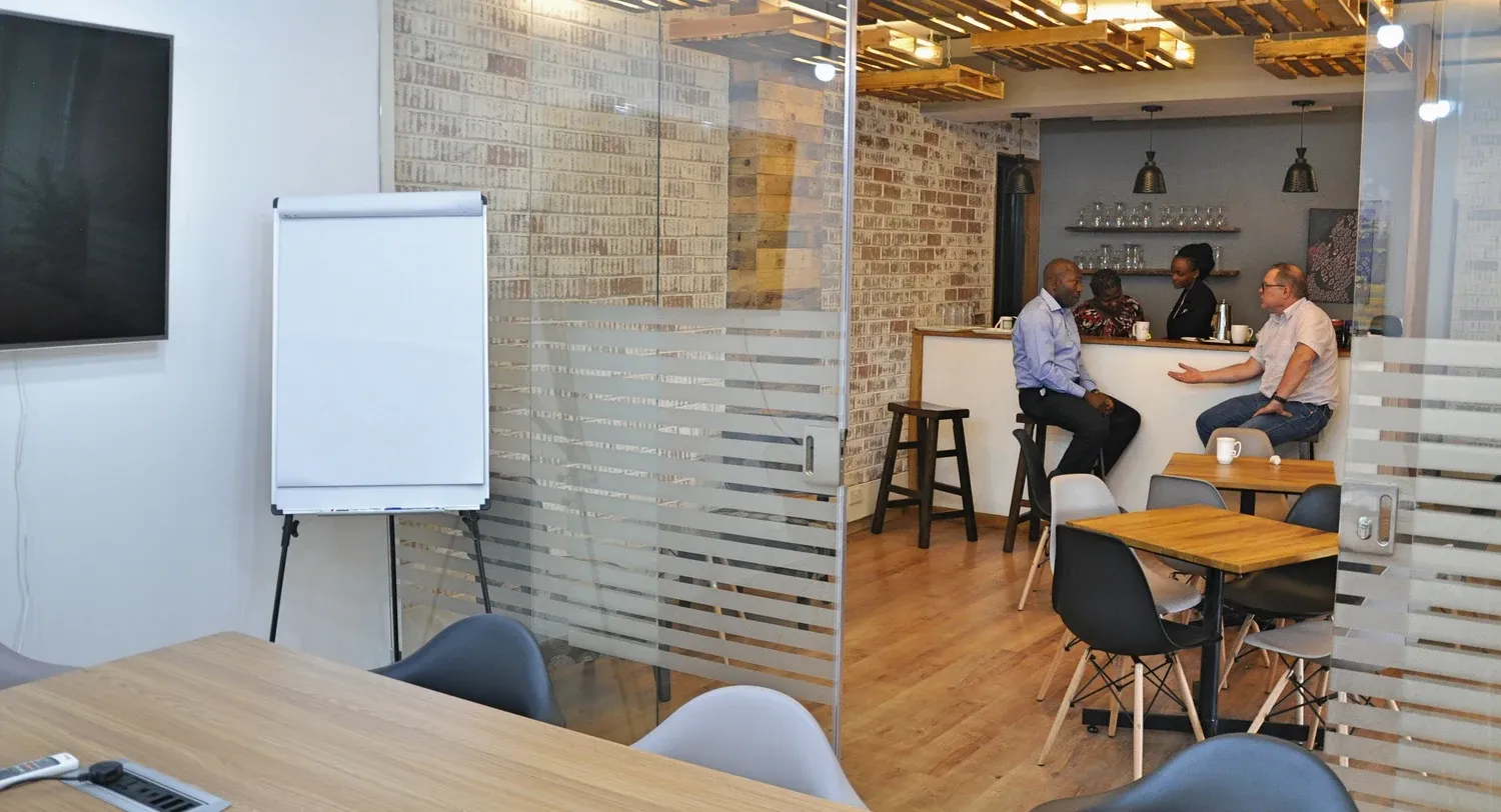 Sustainet shared working area opening onto the coffee bar